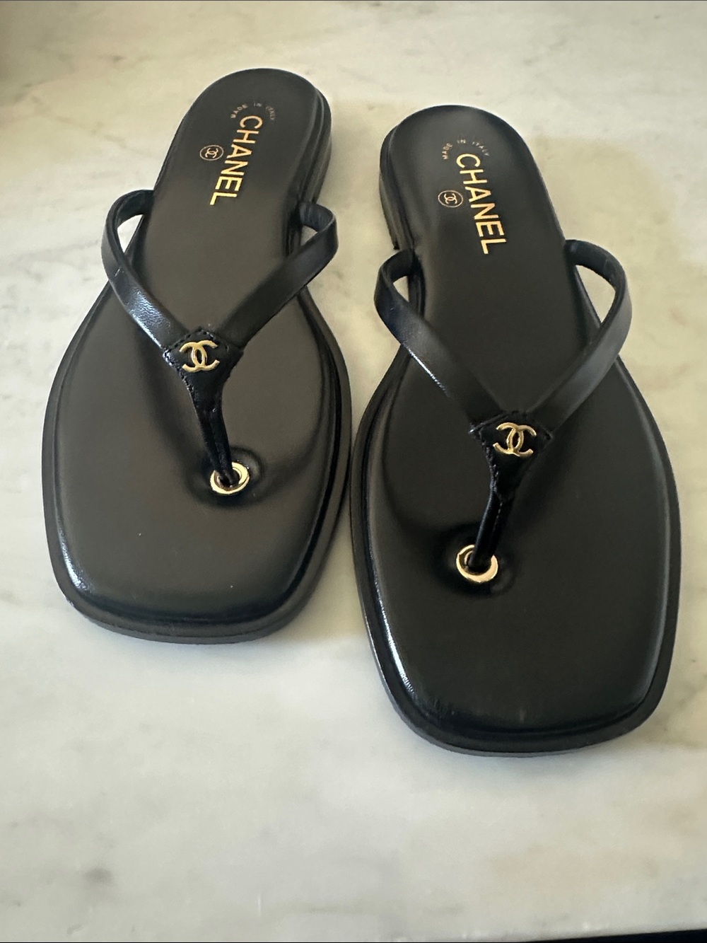 CHANEL Black Leather Thong Sandals with Gold Logo Accent